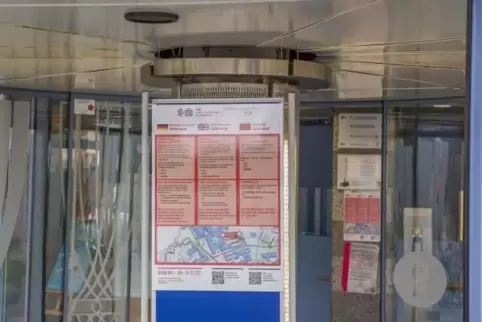 Am Eingang der Uni-Kinderklinik wurden Warnhinweise angebracht; Besucher können sich mit Schutzausrüstung versorgen.