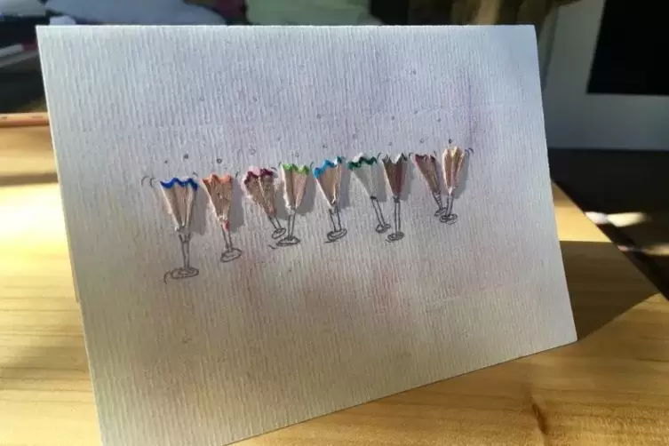 Geburtstagskarte mit neun kleinen tanzenden Sektgläsern aus zurechtgeschnittenem Buntstifte-Spitzerabfall.
