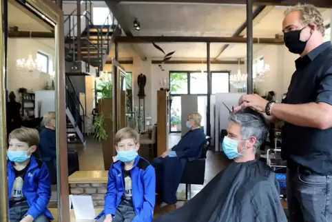 »Ich hätte mir nie im Leben sechs Wochen Urlaub gegönnt«, sagt Frisör Ulrich Ullmayer. Hier schneidet Michael die Haare. Sohn Jo