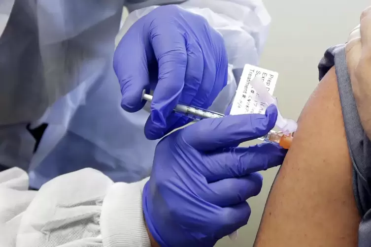 Eine Versuchsperson erhält eine Spritze mit einem potenziellen Impfstoff gegen Covid-19. 