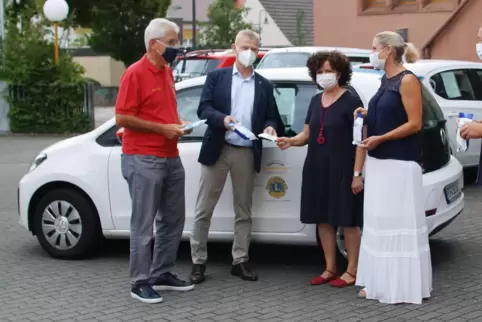 Masken-Übergabe mit Maske. Schutzausrüstung ist in der Pandemie-Zeit wichtig. 