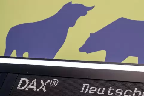 Bulle und Bär sind über dem Schriftzug Dax an der Frankfurter Börse zu sehen. Sie symbolisieren das Auf und Ab der Kurse.