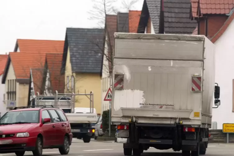 Ortsmitte Harthausen: Auf der Speyerer Straße, die in die Schwegenheimer Straße übergeht, ist ein Lastwagen unterwegs. Die Anwoh