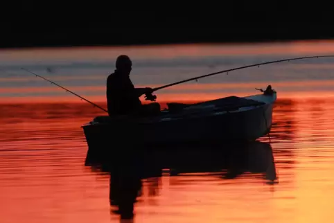 Ein Angler im Kahn auf einem See. So etwas ist Naturschützer Ewald Marx im Winter ein Dorn im Auge.
