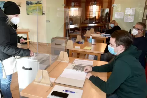 Corona-konform hinter Spuckschutz: Die Wahlhelfer Jannik Stöckmann, Patrick Seitz und Elke Bauer warten in Orbis auf Wähler aus Corona-konform hinter Spuckschutz: Die Wahlhelfer Jannik Stöckmann, Patrick Seitz und Elke Bauer warten in Orbis auf Wähler aus