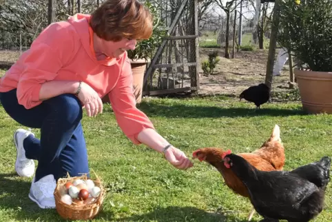 Martina Dopp mit Hühnern – und einem Korb voller bunter Eier.