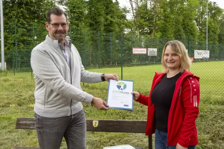 ZAK-Vorstand Jan Deubig übergibt das Preisgeld an Frederike Busch, Trainerin des Kaiserslauterer Schwimmsportklubs. 