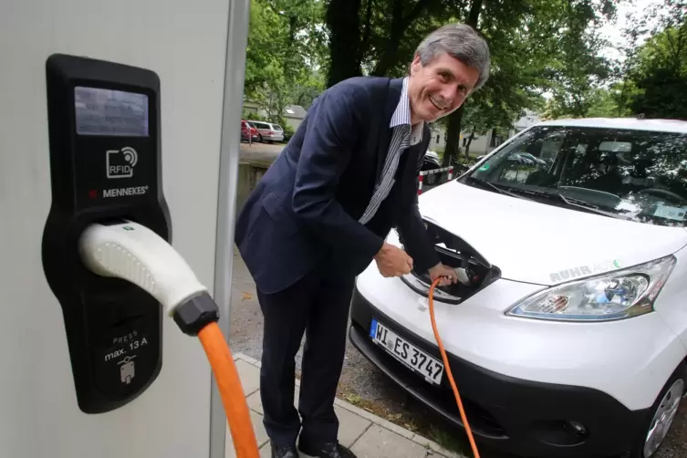 Automarkt-Experte Ferdinand Dudenhöffer, hier beim „Betanken“ eines Elektroautos. 