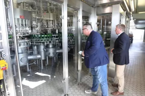 Sie läuft. Wirtschaftsstaatssekretär Andy Becht (li.) und Brauereichef Roald Pauli inspizieren die neue Abfüllanlage. 