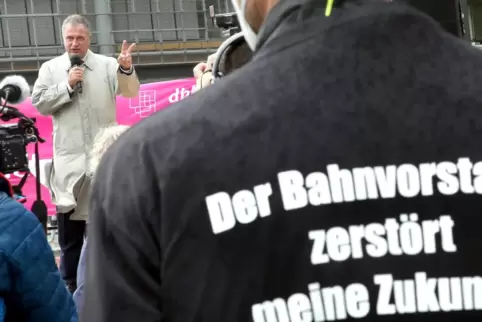 Streikende in Berlin. Im Hintergrund spricht der Chef der Lokführergewerkschaft GDL, Claus Weselsky. 