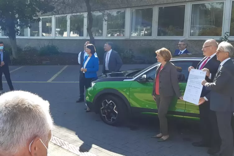 Fototermin an einem Elektro-Auto aus dem Hause Opel: ACC-Chef Yann Vincent, Peter Altmaier und Malu Dreyer (von rechts)