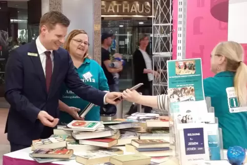 Centermanager Christoph Feige mit Sirikit Schorer und Gudrun Völker (Vorstand Saluma) bei der Bücherbörse im Rathaus-Center. 