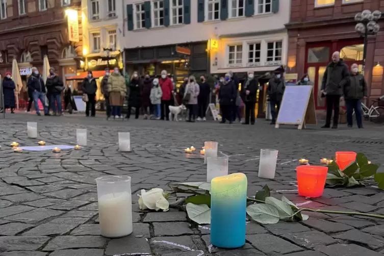  Kerzen und Blumen für die Opfer der Pandemie und als Zeichen der Solidarität vor der Stiftskirche. 