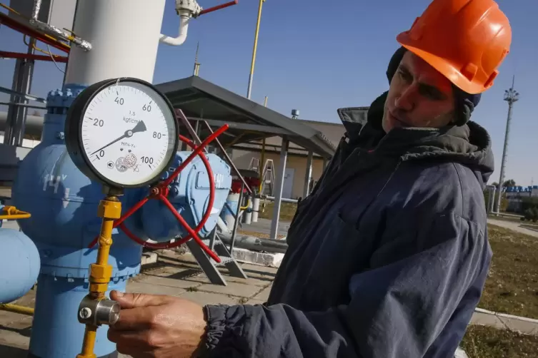 Ein russischer Arbeiter überprüft den Druck einer Pipeline.