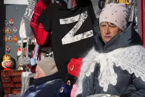 In St. Petersburg geht eine Frau an einem Souvenirladen vorbei, in dem T-Shirts mit dem Buchstaben Z verkauft werden. 