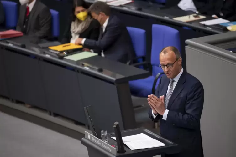 Unionsfraktionschef Friedrich Merz im Bundestag vor dem leeren Kanzlersessel. Der Regierungschef ist auf Japan-Reise und fehlte 
