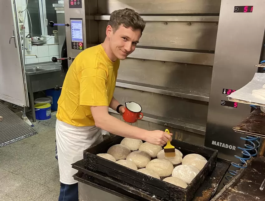 RHEINPFALZ-Volontär Timo Konrad hilft beim Vorbereiten der Brote, bevor diese in den Ofen kommen.