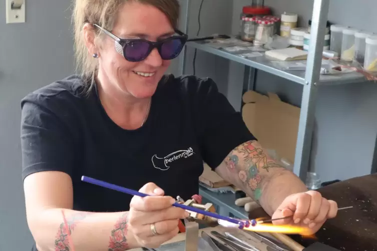 Sandra Gantert wickelt Glasperlen von Hand. Hier arbeitet sie in ihrem Werk- und Verkaufsraum in Rodalben.