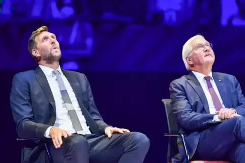  Dirk Nowitzki (links) und Bundespräsident Frank-Walter Steinmeier (SPD) schauen sich staunend sich die Präsentation des Trikots