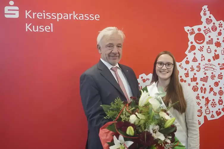 Kreissparkassen-Vorstand Helmut Käfer überreicht einen Blumenstrauß sowie einen Gutschein an Kuseline Lena Stutzkeitz.