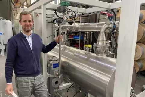 Patric Burkhart an einem von Aura gebauten Wärmeerzeuger. 