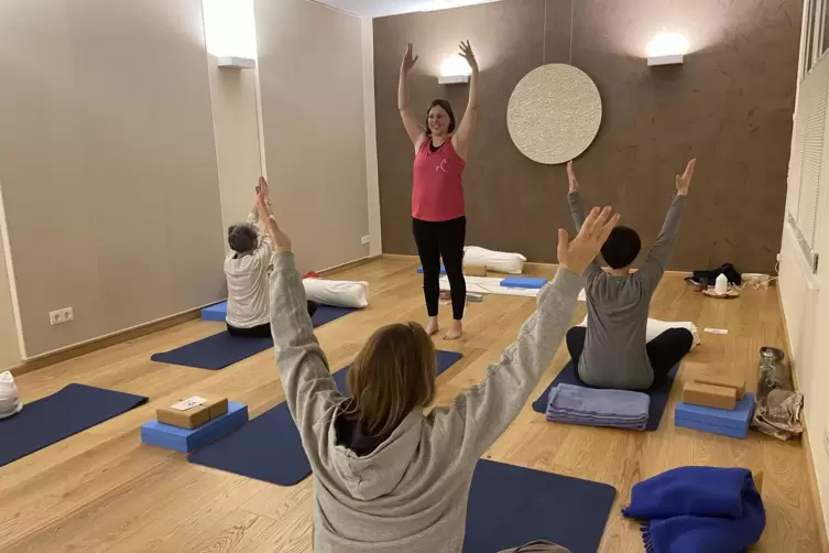 Mit der Einatmung die Arme in die Höhe heben: In der Yogastunde zeigt Miriam Ruberg, wie körperliche Übungen mit Konzentration u