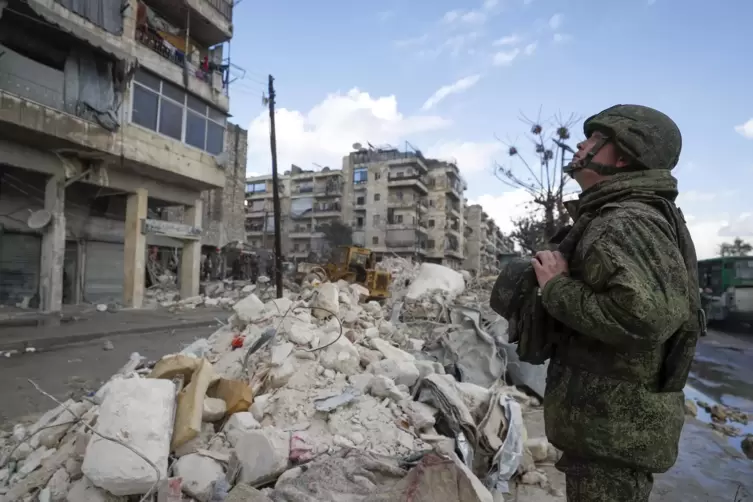In Aleppo inspiziert ein russischer Soldat die Trümmer eingestürzter Gebäude.