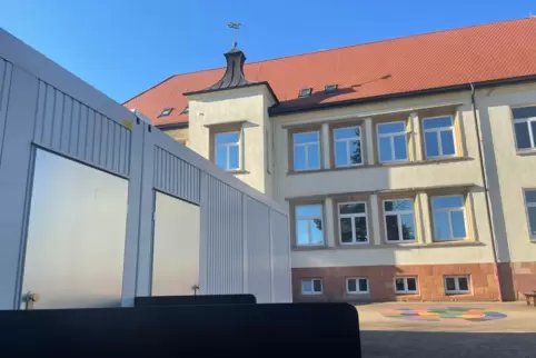 Links stehen einige der Container an der Grundschule Einöd, in denen die Schüler lernen. 