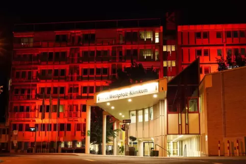 Bei der Protestaktion wird das Westpfalz-Klinikum rot angestrahlt.
