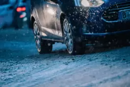 Ein Auto fährt auf einer verschneiten Straße