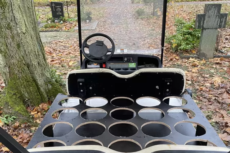 Mit einem kleinen Wagen werden die Urnen zum Gr&auml;berfeld transportiert.