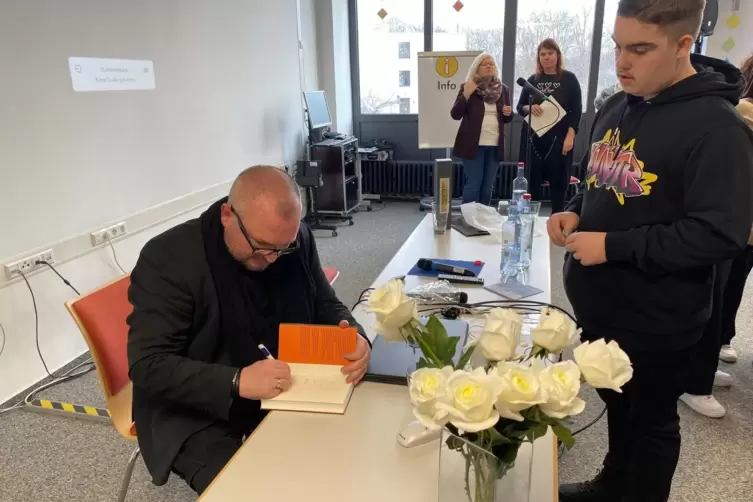 Zum Schluss noch ein Autogramm: Einige der Sch&uuml;ler kaufen nach der Lesung Tim Pr&ouml;ses Buch &bdquo;Jahrhundertzeugen&ldquo;. 