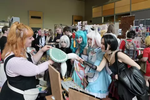 Gut besucht: Cosplayerinnen aus Stuttgart schauen sich einen Stand auf der NonkiCon an