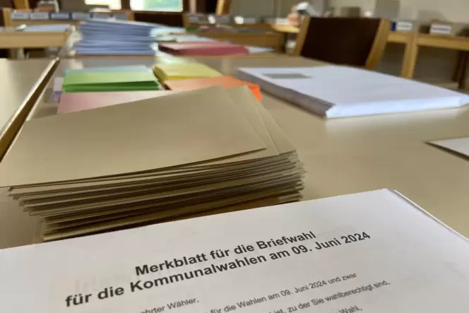 Im Wahlamt der Verbandsgemeinde Kusel-Altenglan liegen mehrere Stapel Stimmzettel auf einem Tisch. Mehr als 5600 Briefwahlanträg