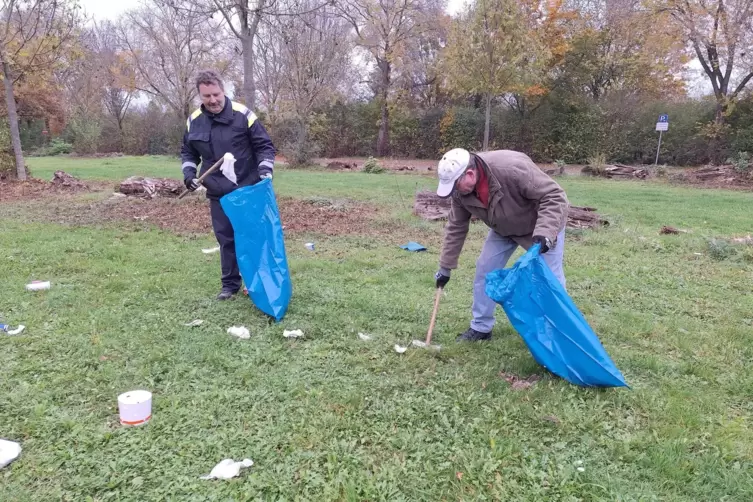 Werner Bigott (links) und Jochen Kapper sind ein Sammelteam und befreien den Parkplatz von Essensverpackungen.
