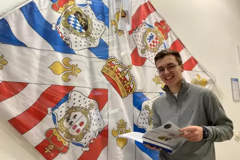 Vor der Fahne des Regiments Royal Deux-Ponts im Zweibrücker Rathaus blättert Lars Müller in seiner Facharbeit. Vor der Fahne des Regiments Royal Deux-Ponts im Zweibrücker Rathaus blättert Lars Müller in seiner Facharbeit.