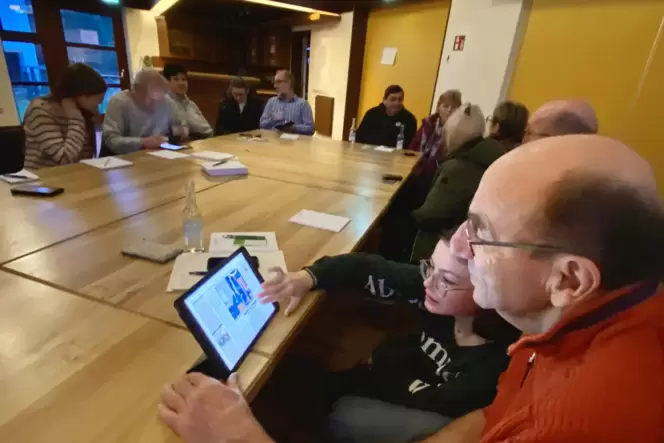 RHEINPFALZ-Praktikantin Johanna Reis zeigt Karl-Heinz Cloß aus Rehweiler die RHEINPFALZ-App.