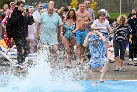 Besucher des Freibads „Sonnenbad“ springen zur Eröffnung des Freibads in das Wasser des Beckens. 