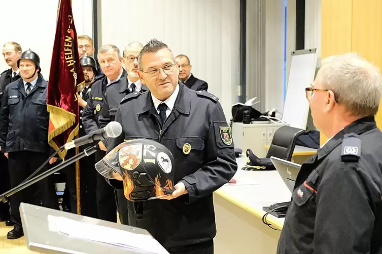 Karl-Heinz Roth (rechts) vom Feuerwehr-Stadtverband Pirmasens &uuml;berreicht Frank Theisinger einen Helm zum 175-j&auml;hrigen Bestehen d