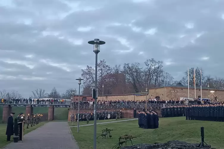 Gel&ouml;bnis im Fackelschein vor vielen Zuschauern.