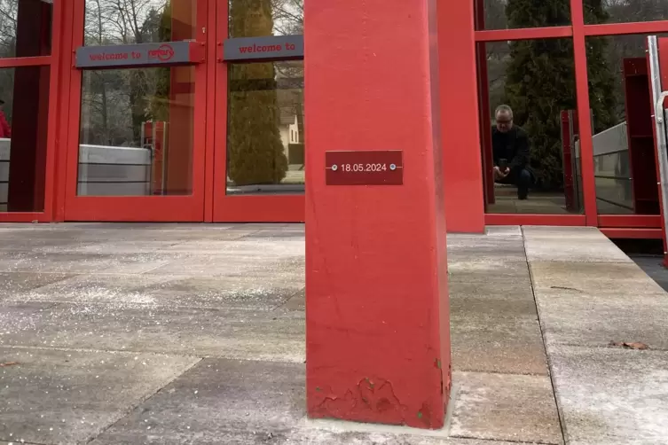 Ein Pfosten am Windfang vor dem Eingang tr&auml;gt eine Plakette mit der Hochwassermarke vom 18. Mai 2024.