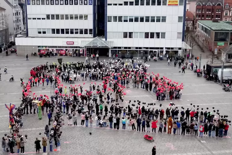 Rund 500 Kinder und Jugendliche haben sich an der Postkarten-Aktion auf dem Kaiserslauterer Stiftsplatz beteiligt. Sie bildeten 