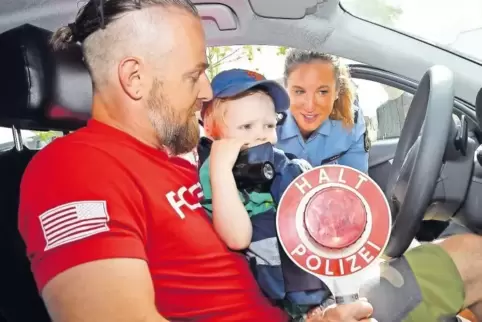 Christian Stuhlfauth inspiziert mit seinem Sohn Jona Lischer ein Dienstfahrzeug der Polizei.