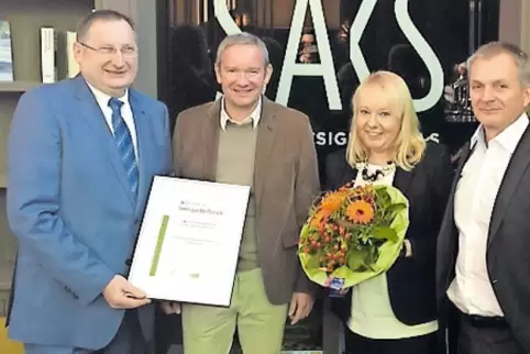 Hans Sachs bekommt die Umweltauszeichnung von Alf Schulz, daneben Julia Bickmann, Leiterin der Tourist Information, und Stefan W