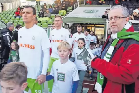Der schreibende Fußballfan Roland Röder mit seinem druckfrischen Buch im Waldstadion: Gerade läuft die Mannschaft ein – vorn mar