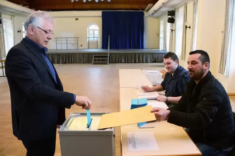 Rudolf van Venrooy, der hier seine Stimme abgibt, ist neuer Ortsbürgermeister von Schönau. Am Tisch die Wahlhelfer Tobias Bock (