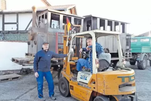 Walter Brauchler hebt mit dem Stapler das Modell auf den Anhänger. Ralf Winkelmann übernimmt den Transport mit seinem Unimog.