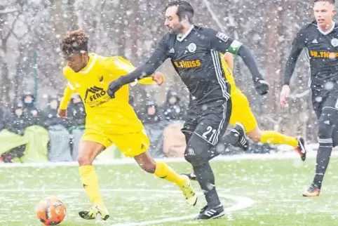 Leise rieselt der Schnee: SVM-Stürmer Jemal Kassa (im gelben Trikot) im Laufduell mit dem Kapitän des FC Homburg, Marc Gallego.