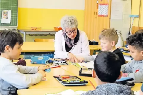 Szene an der Husterhöh-Schule: Die Kinder der vierten Klasse erledigen ihre Matheaufgaben mit Hilfestellung von Anne Hammel.