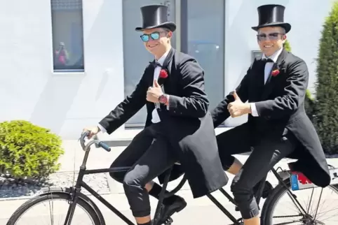 Die Kerweborsch Manuel Kistenmacher und Ramon Büsken sind gut gelaunt auf ihrem Oldtimer-Tandem unterwegs.
